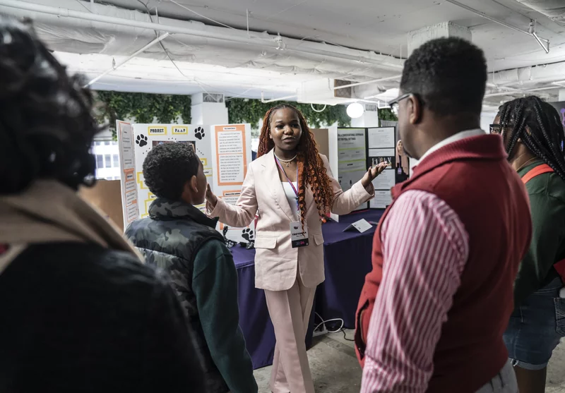 At the National STEM Festival, 12th-grader Treyonna Sullivan talks with visitors about her "Project Poop," created to encourage pet owners in her community to dispose of their pet's waste.
Dee Dwyer for NPR